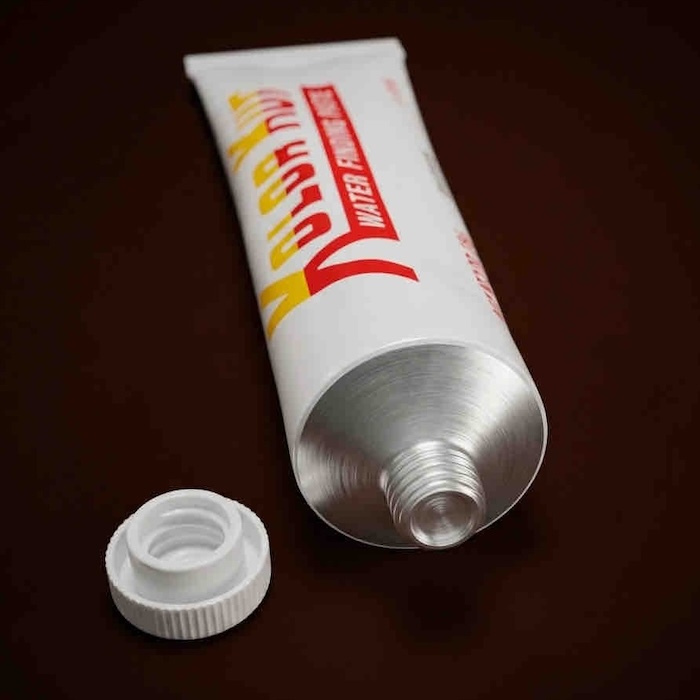 Counterfeit Kolor Kut Water Finding Paste tube with cap removed, showing internal seal