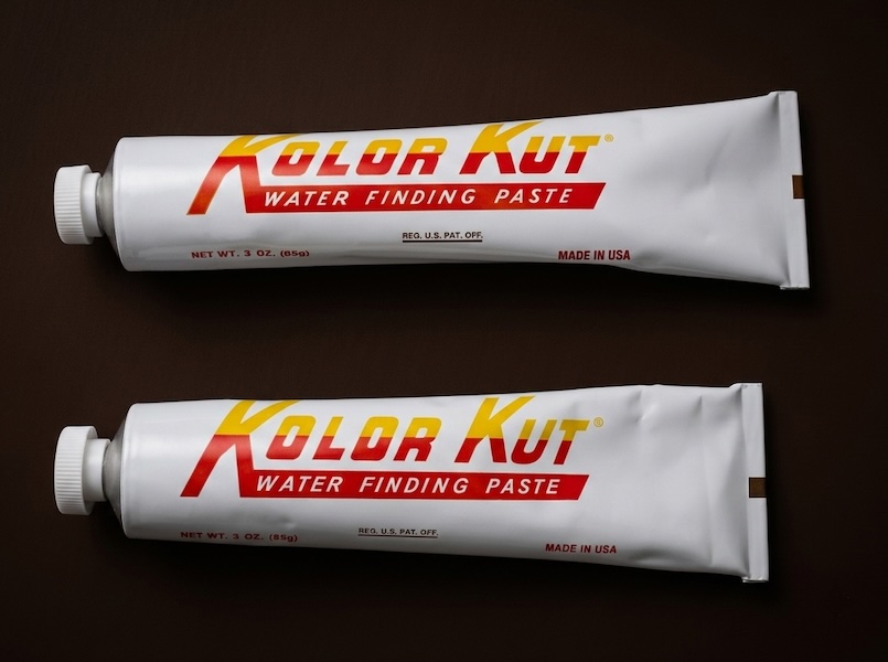 Side-by-side size comparison of counterfeit and genuine Kolor Kut Water Finding Paste tubes